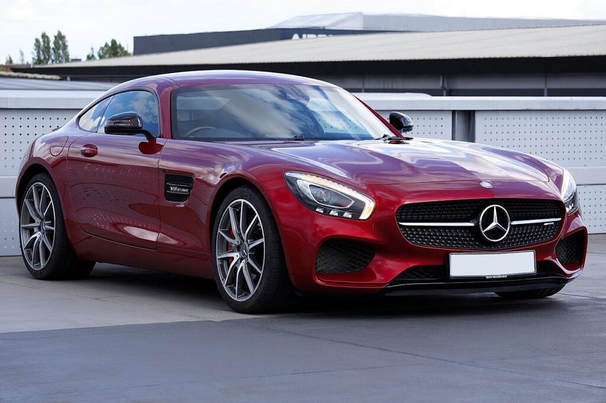 A red Mercedes Benz parked in an Illinois driveway.