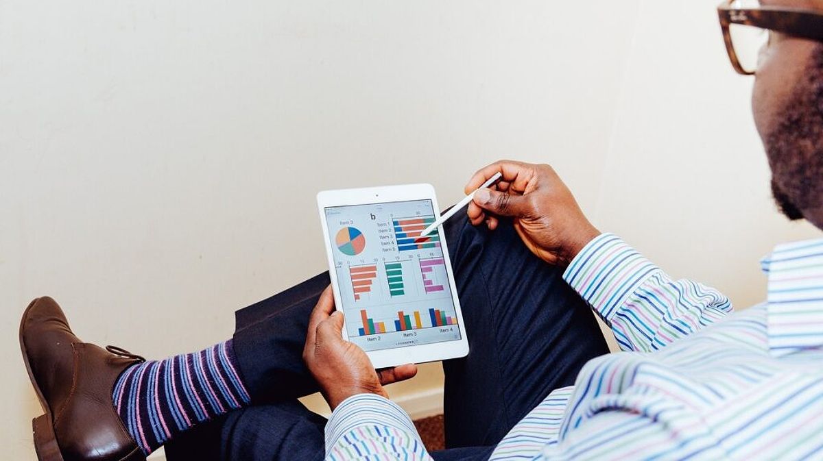 Man watching graphing result with his tablet