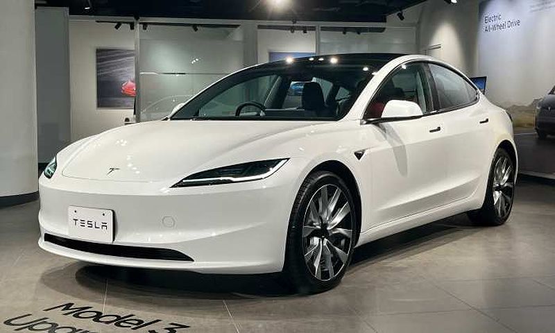 Photo of a white 2023 Tesla Model 3 in a showroom